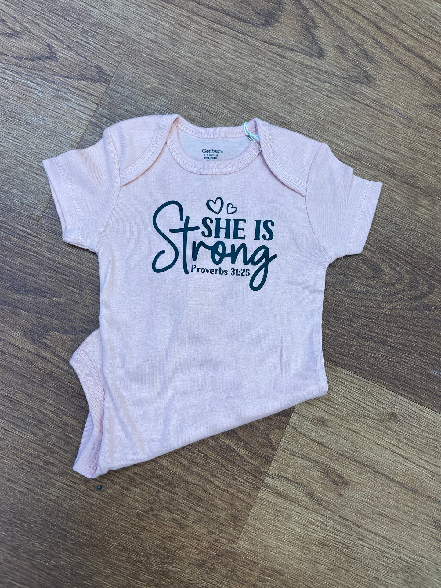 She is Strong Onesie